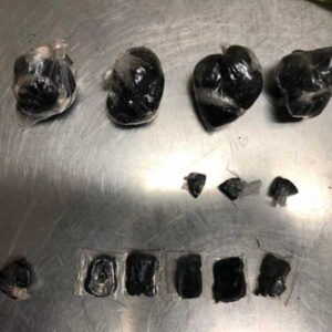 buy black tar heroin online. this is a photo of black tar heroin rapped in small plastics like balls on a silver tray