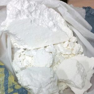 buy bolivian cocaine online, this is a photo of cocaine from Bolivia on a table with some already put in a medical plastic for shipping